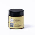 Jar with a black lid and yellow label on a white background