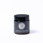 Black jar with a label on a white background