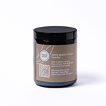 Jar of 100% Makhir Ginger Powder with a black lid on a white background