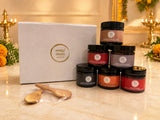 The Humble Gift Box with six Humble Origins jars and wooden spoons beside a white gift box, styled for Diwali