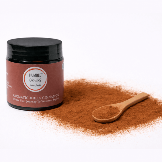 Jar of Humble Origins Aromatic 3Hills Cinnamon with a wooden spoon on a white background