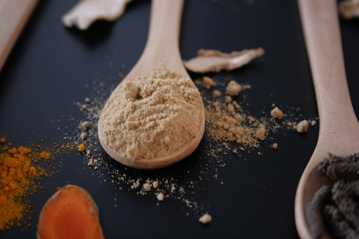 Humble Origins Makhir Ginger on a wooden spoon on a black table