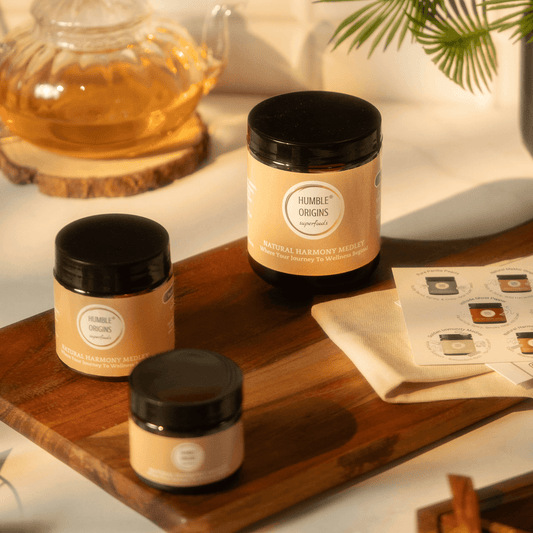 Three jars with black lids on a wooden tray, featuring 'Humble Origins' branding.